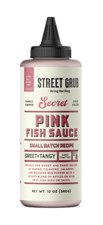 A can of pink fish sauce with the words " street grub secret pink fish sauce small batch recipe sweet tangy."